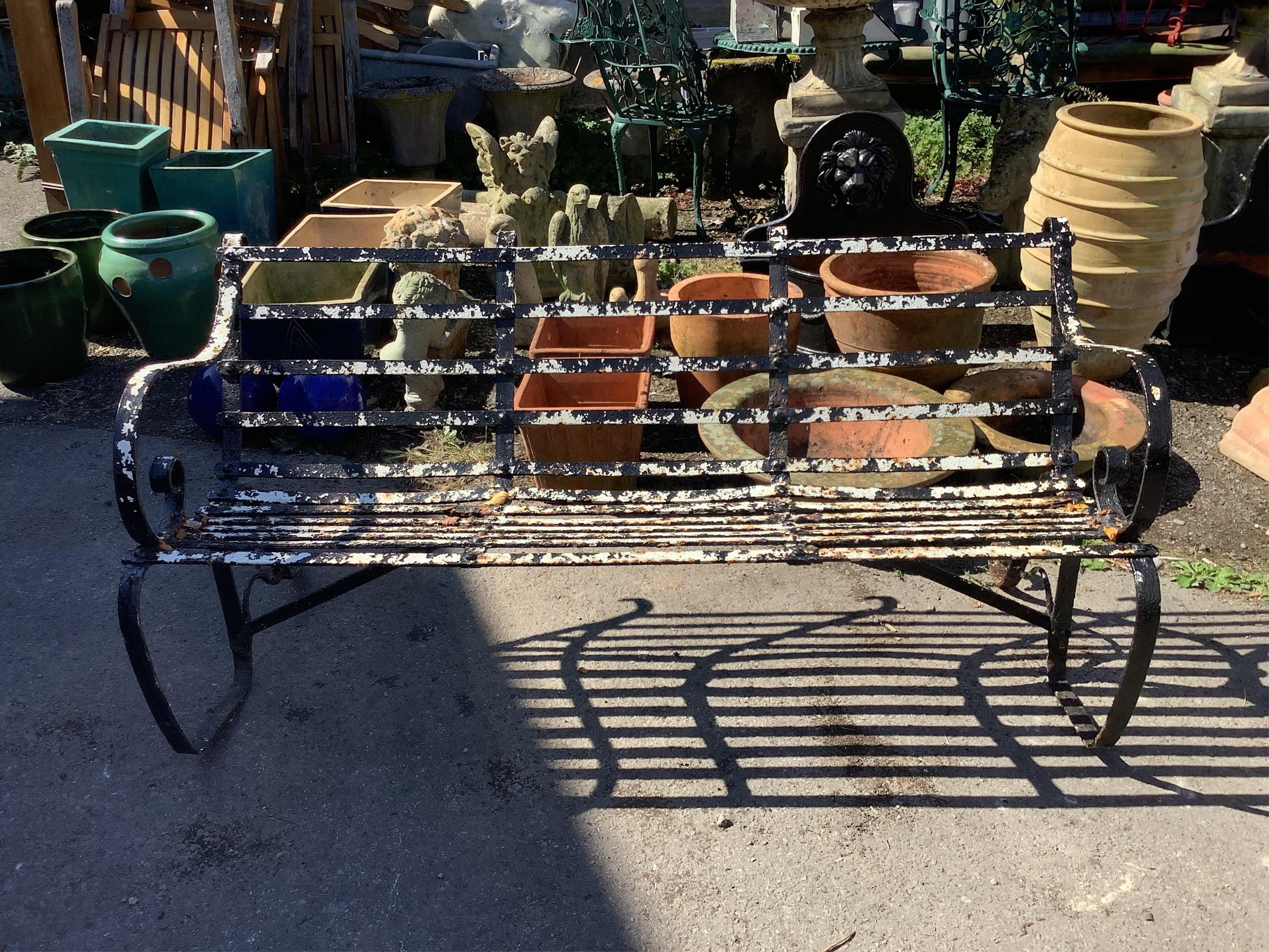 A painted wrought iron garden bench, width 147cm, height 73cm. Condition - fair